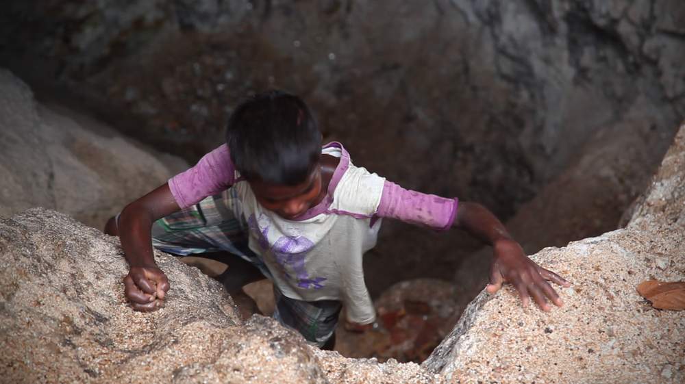 Sandeep, 10, climbs out of a Mica mine in Jharkhand.
