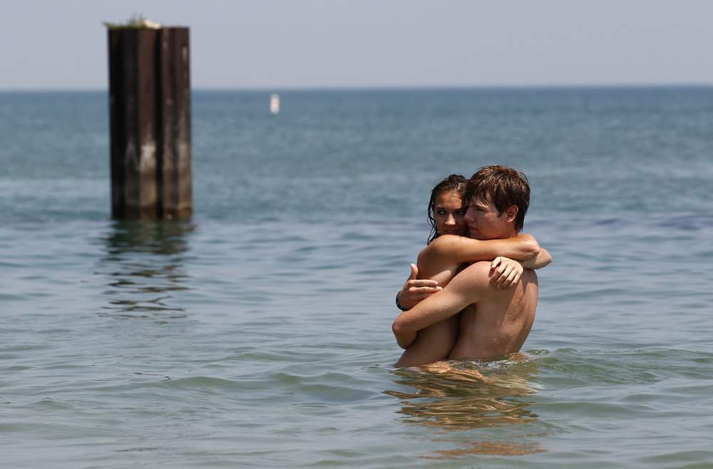 Jake Tatro and Dana Dubois try to keep cool in the water at North Avenue Beach in Chicago, July 20, 2011, on a day when the heat index was expected to exceed 110 degrees Fahrenheit or 43 degrees Celsius. REUTERS\/Jim Young