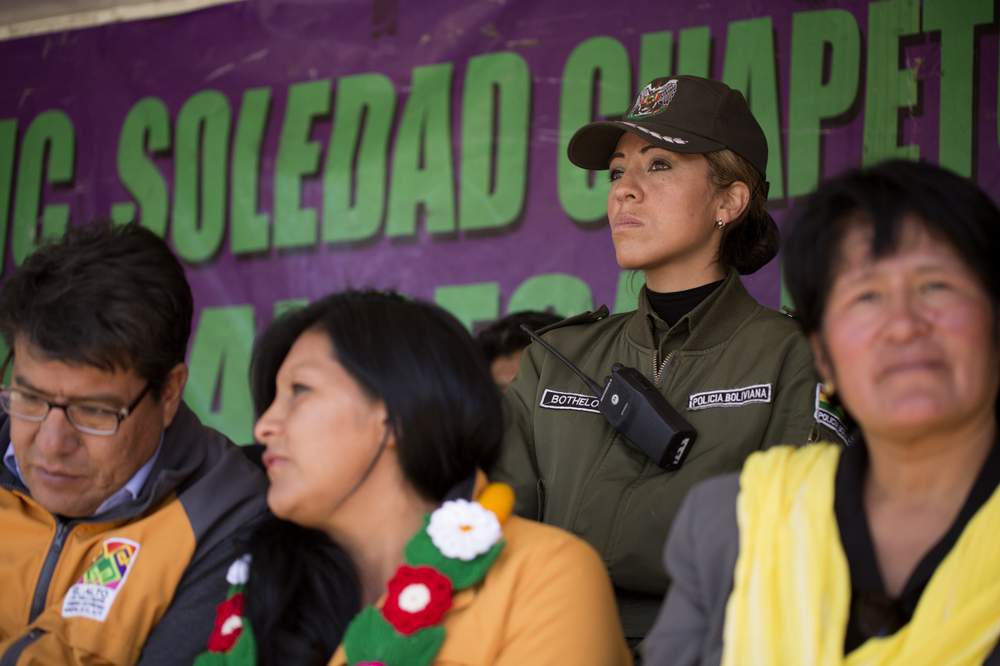 Soledad Chapeton&#39;s bodyguard Carla Botelo stands behind&amp;nbsp;El Alto&#39;s mayor&amp;nbsp;during a public event.