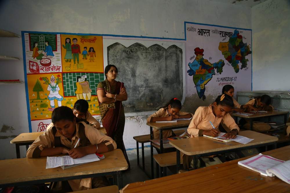 A teacher stands in her classroom, Soda village, India. 