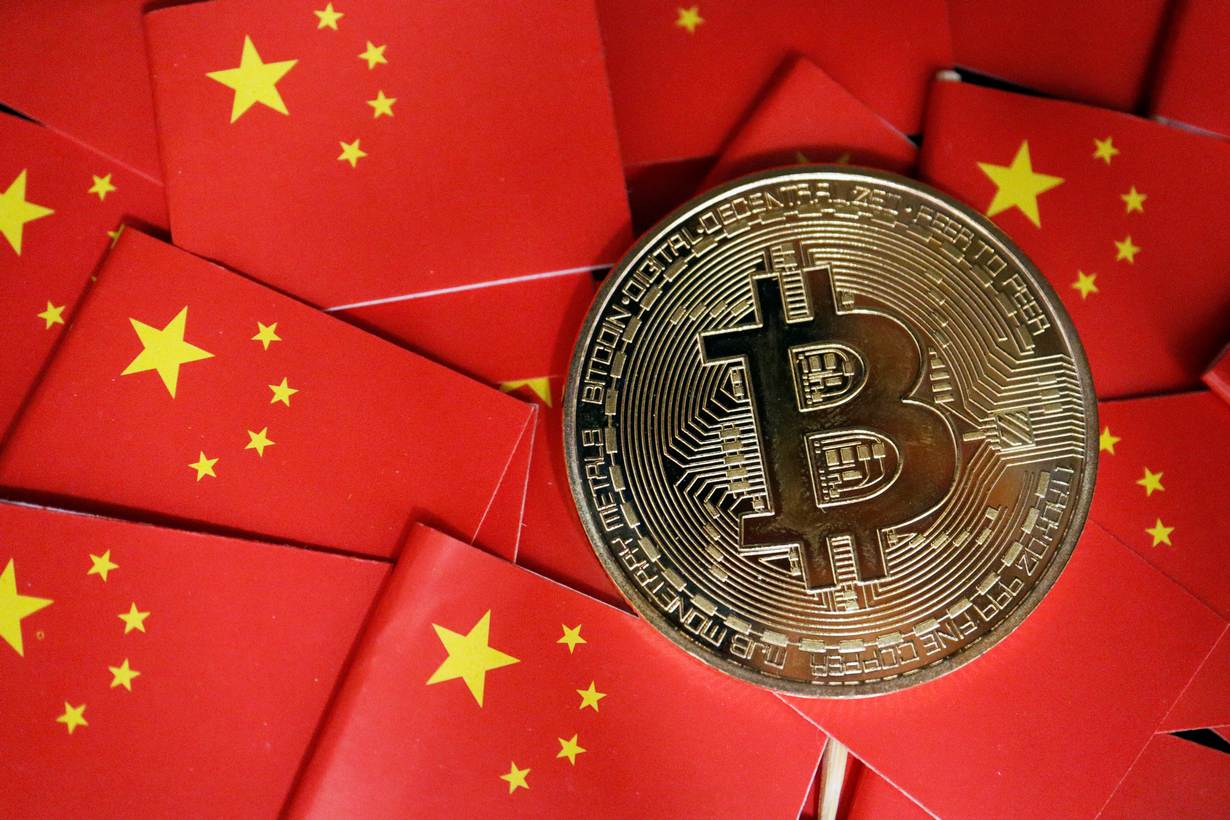 A representation of Bitcoin cryptocurrency is seen amid China's flags in this illustration picture taken September 27, 2021. REUTERS/Florence Lo/Illustration