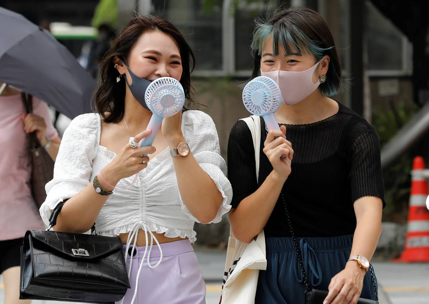 Soaring summer temperatures can make wearing a coronavirus-blocking mask a ...