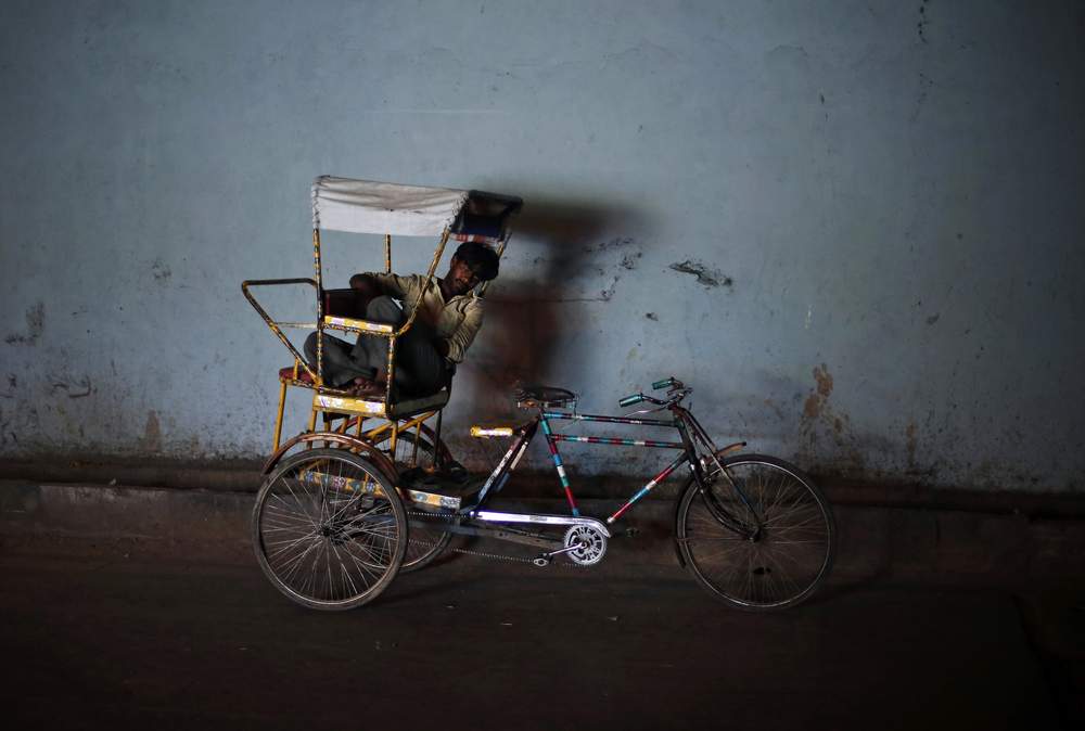 A man takes a nap on his cycle rickshaw under a bridge on a hot summer day in the old quarters of Delhi, June 11, 2014. REUTERS\/Adnan Abidi&amp;nbsp;