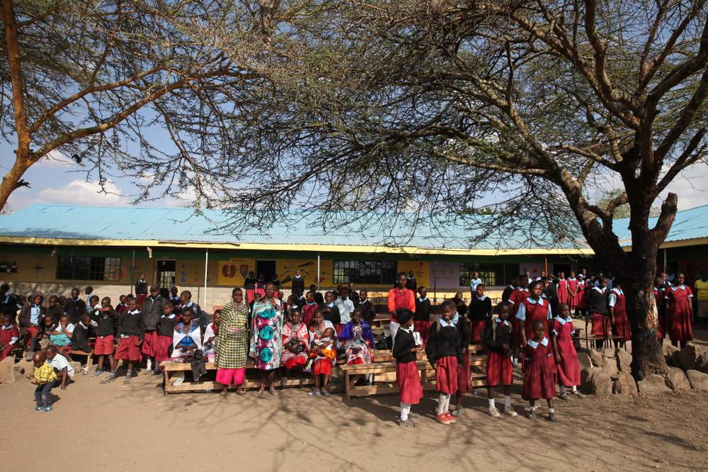 Students and parents standing outside a school in Kajiado, Kenya.